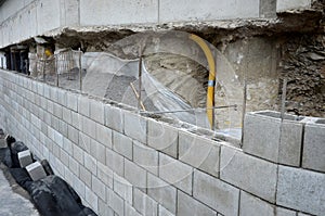 Ugly holding a road notch of a bridge forecourt tunnel. retaining wall with concrete grouting is covered with fake, optically pret photo