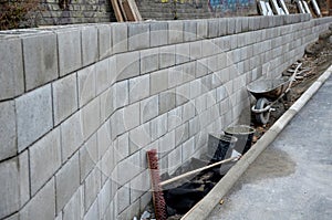 Ugly holding a road notch of a bridge forecourt tunnel. retaining wall with concrete grouting is covered with fake, optically pret photo