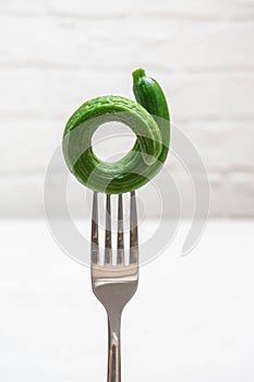 Ugly misshapen cucumber on white background