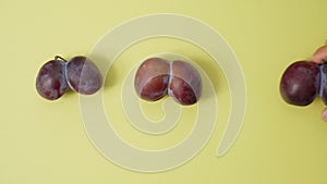Ugly plums and carrot on yellow background. fruits are suitable for food. Concept Reduction of organic food waste