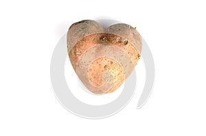 Ugly potato in the heart shape isolated. Food waste concept