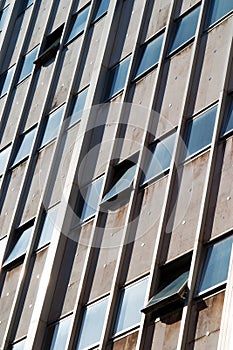 Ugly tower block building with windows opened