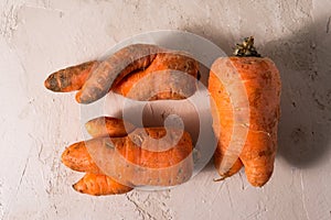 Ugly vegetables, carrots on a light background.funny monster carrot The concept of non-waste production in the food industry