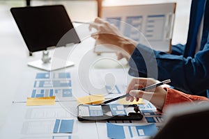 UI developer and ui designer brainstorming about mobile app interface wireframe design with customer breif and color code at