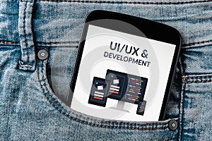 UI/UX design and development concept on smartphone screen in jeans pocket