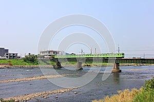 Uji river, bridge, train and urban landscape