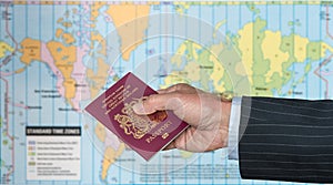 UK Citizen with passport and world map of timezones