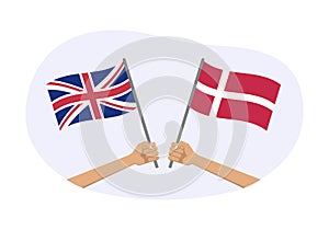 UK and Denmark flags. Danish and British national symbols. Hand holding waving flag. Vector illustration