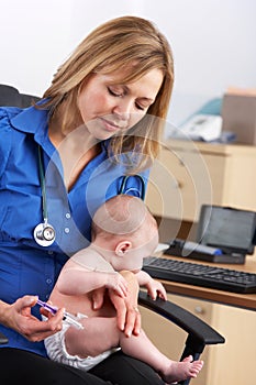 UK doctor vaccinating baby