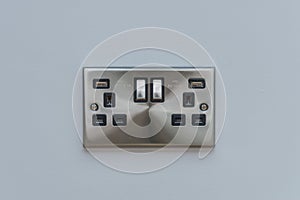 UK double electrical socket on light grey wall. photo