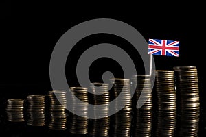 UK flag with lot of coins on black