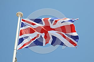 uk flag on a mat in the wind and blue sky