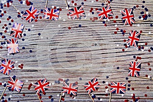 UK flag on wooden background with confetti copy space. the concept of independence day, memory and sorrow
