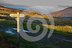 UK footpath finger post catching sun