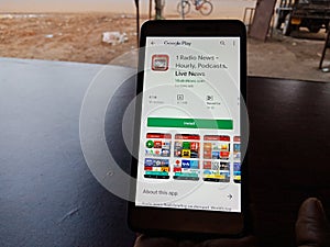 Radio news online android app displayed on smart phone screen holded hand mobile concept in India dec 2019