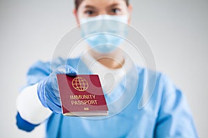 UK NHS doctor holding red global immunity passport