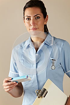 UK nurse holding prescription drug pack