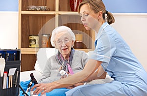 UK nurse visiting senior woman at home