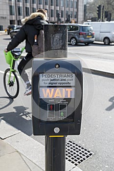 UK pedestrian crossing. Pedestrian crossing button showing WAIT sign on electronic monitor. London. UK