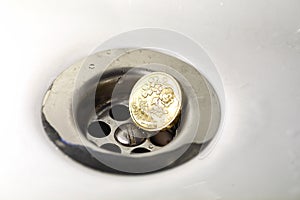 UK Pound Coin in Silver Sink Drain