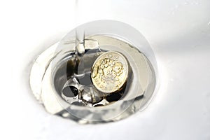 UK Pound Coin in Silver Sink Drain