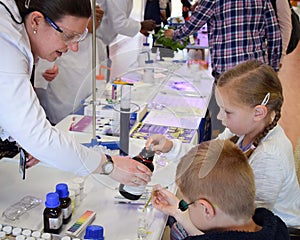 Laboratory chemists tak a day out of the lab to teach children about chemistry as part of the UK STEM, science, technology,engine