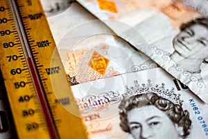 UK ten pound notes and thermometer