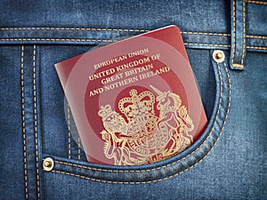UK United Kingdom passport in pocket jeans. Travel, tourism, emigration and passport control concept photo