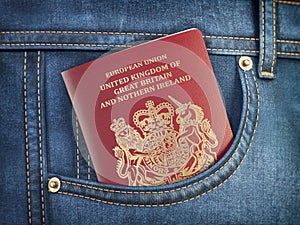 UK United Kingdom passport in pocket jeans. Travel, tourism, emigration and passport control concept