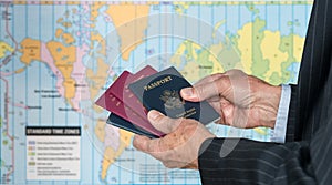 UK or US Citizen with passports and world map of timezones