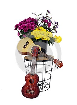 Ukelele guitar on table with bouquet. Vintage retro style.