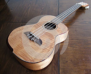 Ukelele Hawaiian Instrument on Wood Table