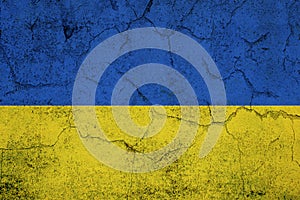 Ukrainain flag on a textured wall, national idendity, war crisis between Ukraine and Russia, politics