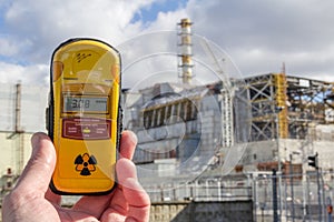 UKRAINE. Chernobyl Exclusion Zone. - 2016.03.19. Dosimeter and Nuclear Power Plant on the background