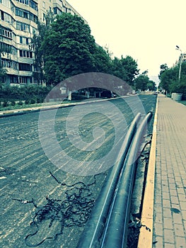 UKRAINE - CONSTRUCTION - Long plastic pipes are seen on a newly constructed street