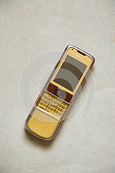 Ukraine Dnepr 19.08.2021 - Nokia 8800 gold lies on gray light paper, old phone, mobile