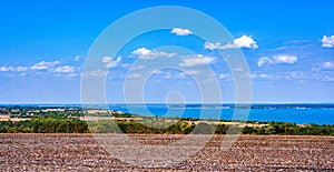 Ukraine.Fields on the shore of the reservoir.The harvest in the fields has been collected.Blue sky with white clouds.