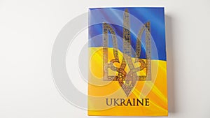 Ukraine flag and coat of arms. Golden trident on cloth flag.