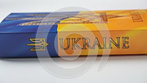 Ukraine flag and coat of arms. Golden trident on cloth flag.