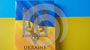 Ukraine flag and coat of arms. Golden trident on cloth flag. National symbol.