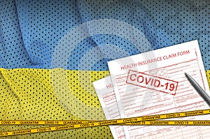 Ukraine flag and Health insurance claim form with covid-19 stamp. Coronavirus or 2019-nCov virus concept