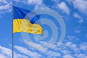 Ukraine flag isolated on the blue sky.