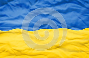 Ukraine flag on a wavy background.