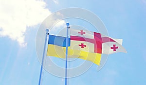 Ukraine and Georgia, flags waving against blue sky