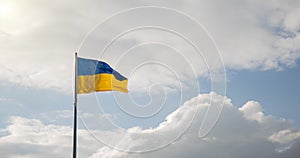 Ukraine independence patriotic concept of blue and yellow banner flagpole blowing on a wind with cloudy background scenic view