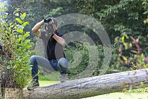 Ukraine, Kyiv, August 25, 2018: A young guy makes a landscape photographing camera Kenon. Removes a small swamp in the forest