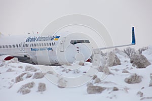 Ukraine, Kyiv - February 12, 2021: Planes at Winter. Aircraft. There is a lot of snow at the airport. Bad weather and visibility.