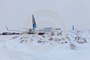 Ukraine, Kyiv - February 12, 2021: Planes at Winter. Aircraft. There is a lot of snow at the airport. Bad weather and visibility.