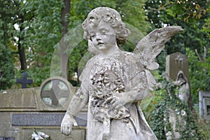 Ukraine, Lviv, Lychakivskiy Cemetery-September 26, 2011: Stone monument statue in the shape of an angel with flowers
