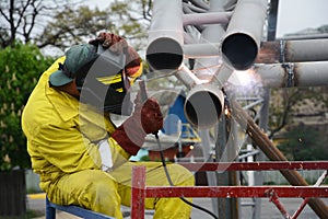 Welding works on welding of metal structures. An electric welder works on scaffolding.